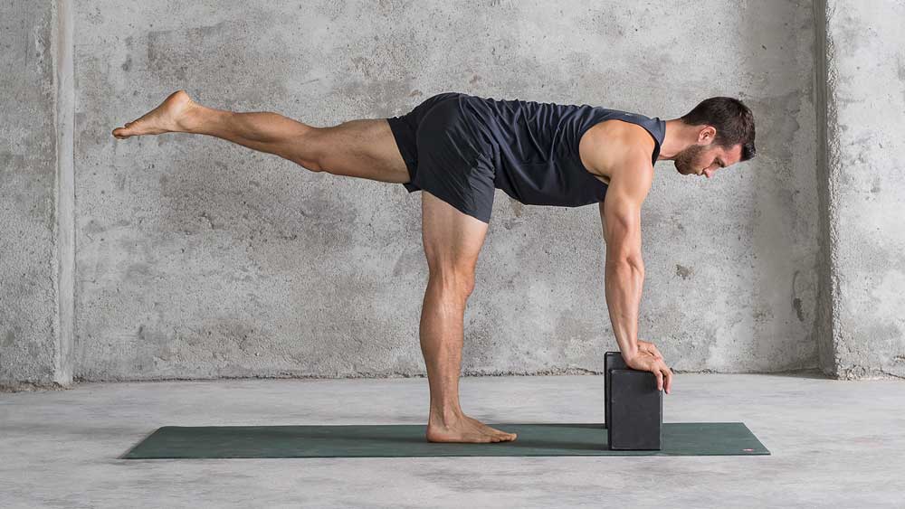 Airplane pose with blocks, demonstrated for people starting beginner yoga for men