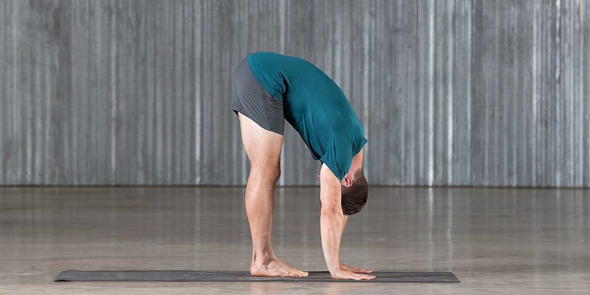 Dean Pohlman in forward fold demonstrating for people starting beginner yoga for men