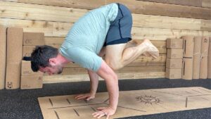 Male Yoga Teacher Demonstrating Crow Pose