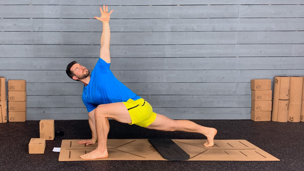 Male yoga instructor demonstrated runners lunge with twist pose on mat for morning yoga routine