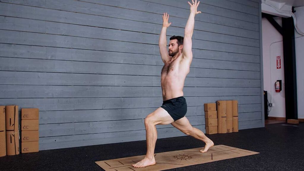 Male Yoga Instructor Demonstrates High Lunge Pose for Better Breathing & Mindfulness