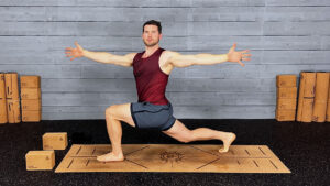Male yoga instructor demonstrated thoracic twist lunge using blocks