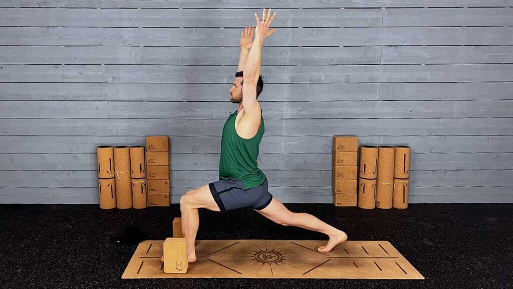male yoga instructor demonstrating hip flexor stretches yoga pose high lunge