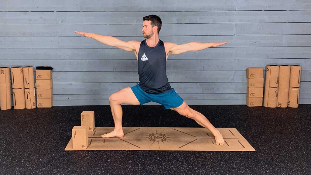 Yoga instructor demonstrating warrior two pose for yoga hip flexor stretch