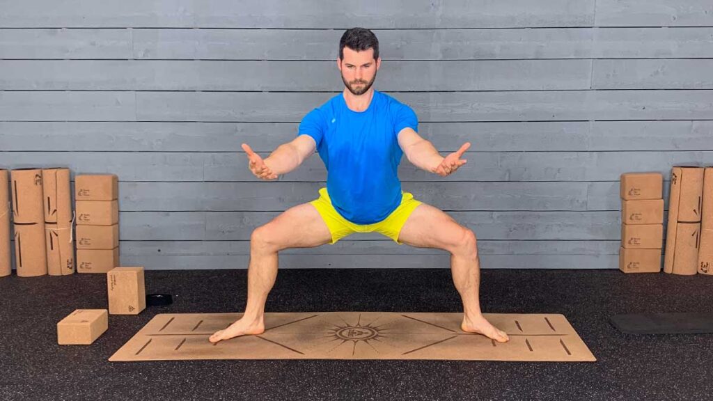 Male yoga instructor demonstrating horse pose for yoga for knee pain workout